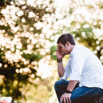 Man Sitting Down and Experiencing Hearing Loss Related Depression