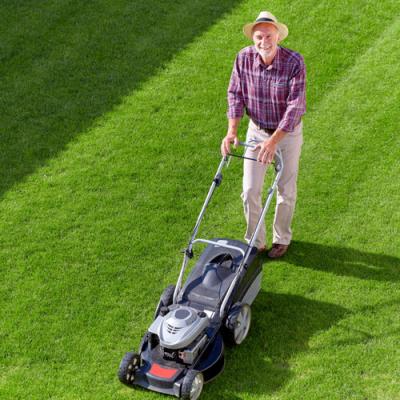 man using lawnmower, a summer hearing hazard