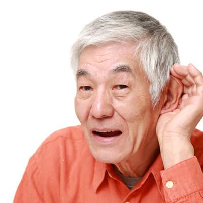 man attempting to hear better with hearing loss