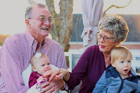 Two grandparents with hearing aids